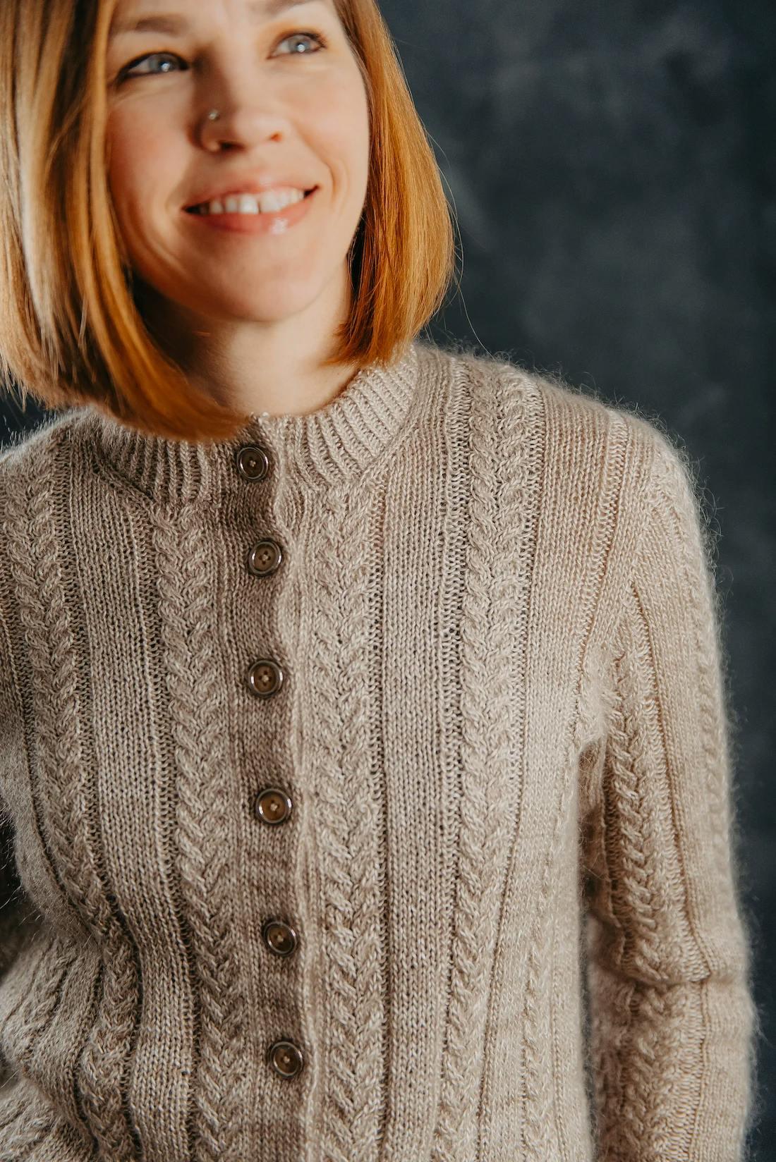 Zanete wearing the Layan Cardigan in sandstorm mohair with a simple cable pattern and wooden buttons down the front