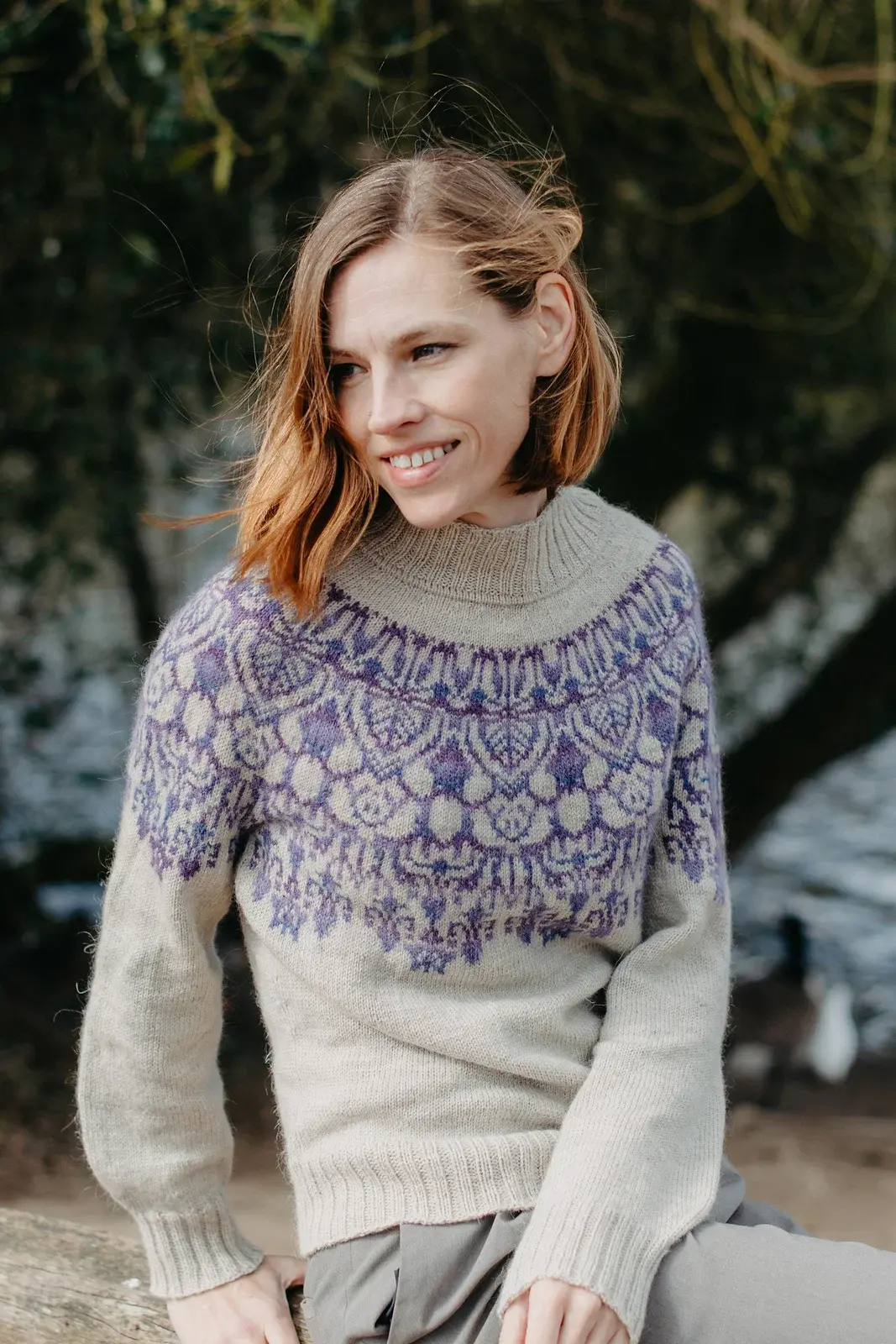 Zanete wearing the seventh Yoke Meditation Series sweater in oatmeal with deep purple floral colourwork around the yoke